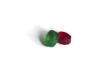 Two green and red lollipops on an isolated background. Two lollipops of red and green color on a white background. Two candies on an isolated background.