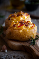Baked potatoes stuffed with cheese, vegetables and rosemary
