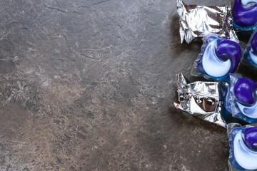 Cleaning tablets for a toilet flush tank and washing capsules on a brown background with place for text. Freshness and purity. House cleaning
