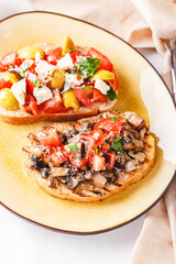 Delicious bruschettas with mushrooms, blue cheese, olives and tomatoes