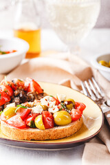 Delicious bruschettas with mushrooms, blue cheese, olives and tomatoes