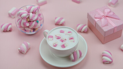 Pink marshmallows with a delicious hot drink. Little girl's Breakfast. High quality photo.