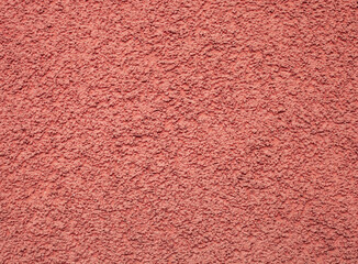Fototapeta premium Texture pink pebble dash stucco on house facade