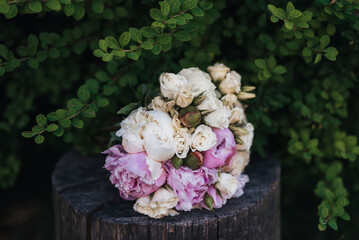 wedding bouquet with white and pink peonies in nature