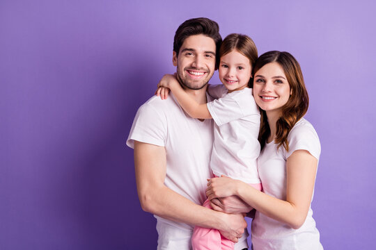 Portrait of nice cheerful careful loving family mommy daddy offspring daughter wearing casual embracing harmony idyllic isolated on bright vivid shine vibrant violet color background