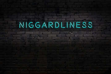 Neon sign. Word niggardliness against brick wall. Night view - obrazy, fototapety, plakaty
