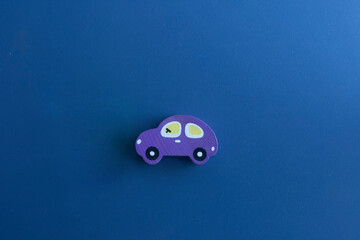 Wooden figurine of a purple typewriter on a blue background
