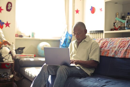 
man with laptop in the living room