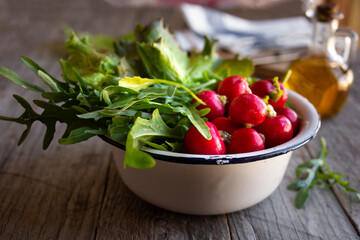 Fresh ingredients for vegetable salad, radish, arugula and lettuce
