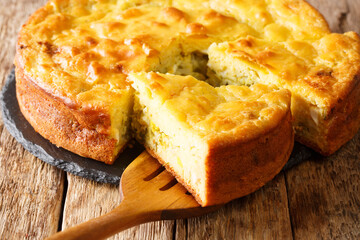 Traditional pie with cabbage, herbs and boiled eggs close-up on a slate board on the table. horizontal