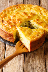 Homemade sliced cabbage pie with herbs and boiled eggs close-up on the table. vertical