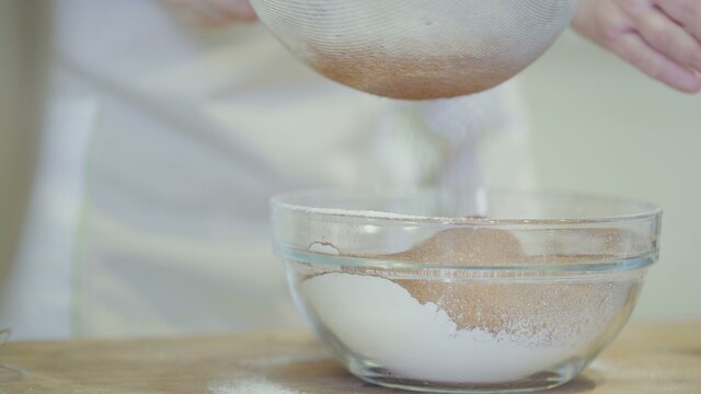 Chef Sifting A Cocoa Powder To Bowl With Flour