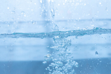 Naklejka na ściany i meble Water droplets moving in waves