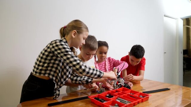 Kids using building kit for car.