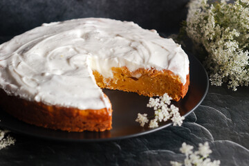 Tasty carrot cake with cottage cheese. Pie on the table. Cake with flowers
