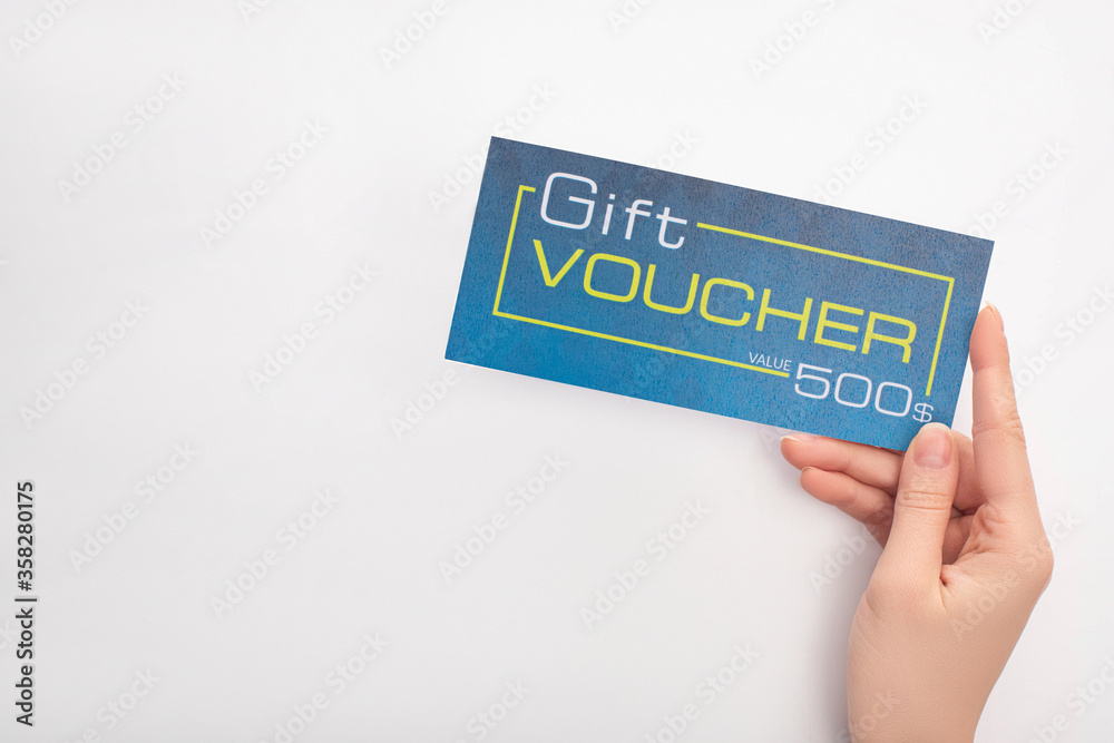 Poster Top view of woman holding blue gift voucher with value and dollar sign on white background