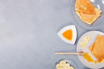 Pancakes honey for breakfast on white gray table