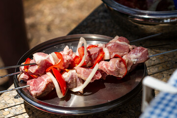 Raw kebabs of pork chopped into pieces and put on skewers ready for frying on the grill.