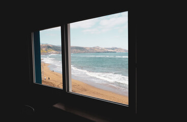 window with views of beach and sea