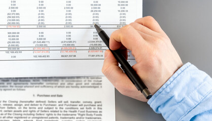 Close up businessman calculate on paper document financial data. Finance concept