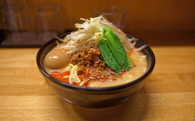 A bowl of spicy Japanese ramen with a generous amount of toppings