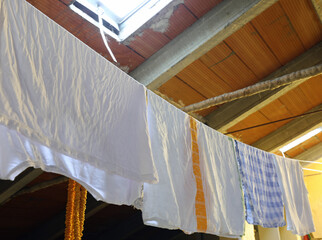 rags and towels hung out to dry after washing in the attic