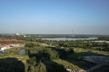 Outskirts of the city industrial zone on the background of a river or lake. Stock photo for design