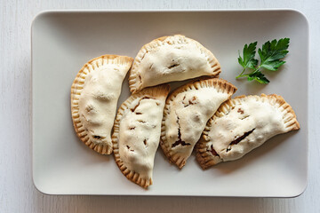 Empanadas with vegetable stuffing on a tray