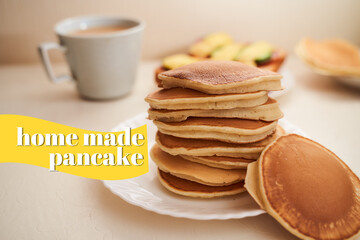 Homemade pancakes are on the table. Nearby is a mug of coffee with milk. Light background. With text effect