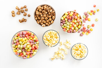 Flavored popcorn on white table top view