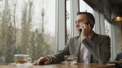 Man with mobile phone in a cafe