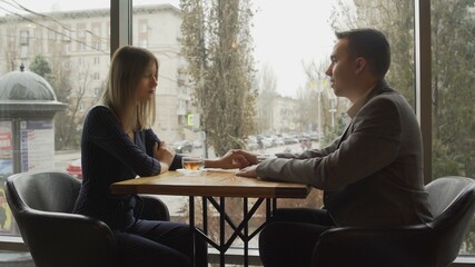 Handsome young man with his woman have a date at restaurant