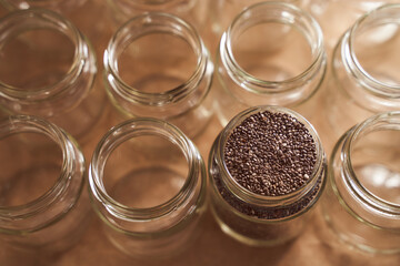 Glass jars. In one of which are the seeds of Chia. promotional photo