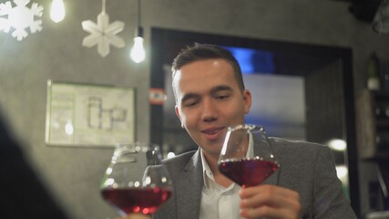 Man is drinking wine at the restaurant on a dating
