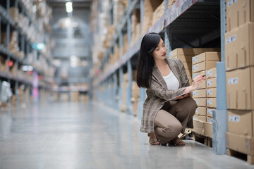 Girl looking for goods with a tablet is checking inventory levels in a warehouse