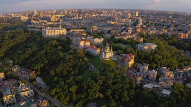 Andriyivskyy Descent and St Andrew's Churchin Kyiv ( Kiev ) city the capital of Ukraine in eastern europe. Beautiful sunset light on historical hills. Top aerial drone panoramic view from above. 