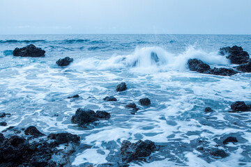 Waves breaking at the rocky coast
