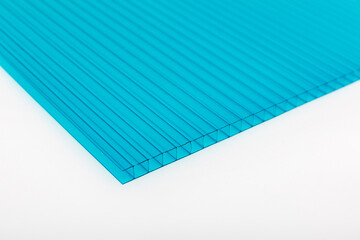 Polycarbonate plastic sheets panels images. PC hollow sheet for translucent roofing close up. Single turquoise (greenish-blue) color on white background