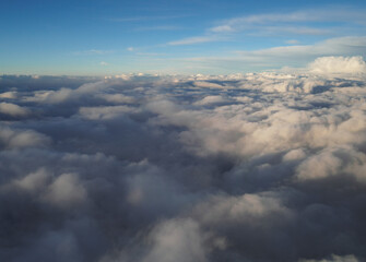 Naklejka na ściany i meble Above the clouds, a view of the blue sky.