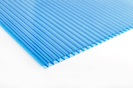 Polycarbonate Plastic Sheets Panels Images. PC Hollow Sheet For Translucent Roofing Close Up. Single Light Blue Color On White Background