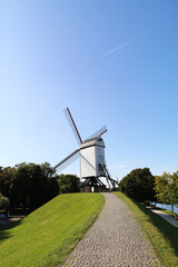 Obraz premium BRUGGE,BELGIUM AUG 12 2017 windmill with blue sky background in Brugge, Belgium.