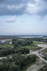 Outskirts of the city industrial zone on the background of a river or lake. Stock photo for design