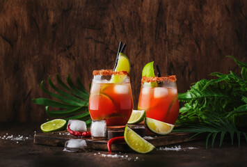 Michelada - Mexican inspired bloody mary alcoholic cocktail with beer, lime juice, tomato juice, spicy sauce and spices, copy space © 5ph