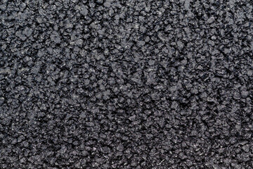 Surface texture of fresh black asphalt road surface, top view