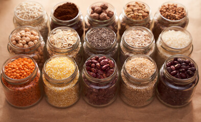 Super food grits in glass jars. Top view. lentils, chickpeas, corn, oats, beans, chia