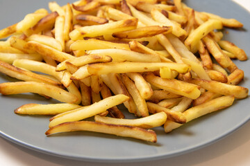 French fries on a blue plate. Close up view