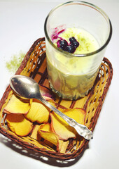 Delicious vanilla pudding with fresh blueberries and Japanese green tea called Matcha as light fat-free desserts made of skim milk. Healthy and diet breakfast