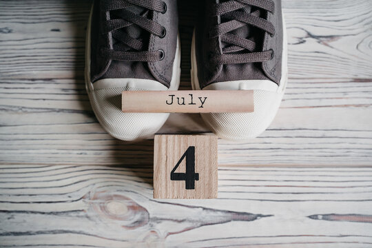 July 4th. Image of july 4 wooden color calendar on grey background. Summer day. Empty space for text. Independence Day Of America
