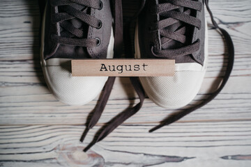 Image of summer wooden color calendar on grey background. Summer day. Empty space for text. 