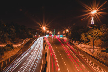 nightlife. night photo with a view of the road and the movement of cars that leave beautiful traces of red and white.